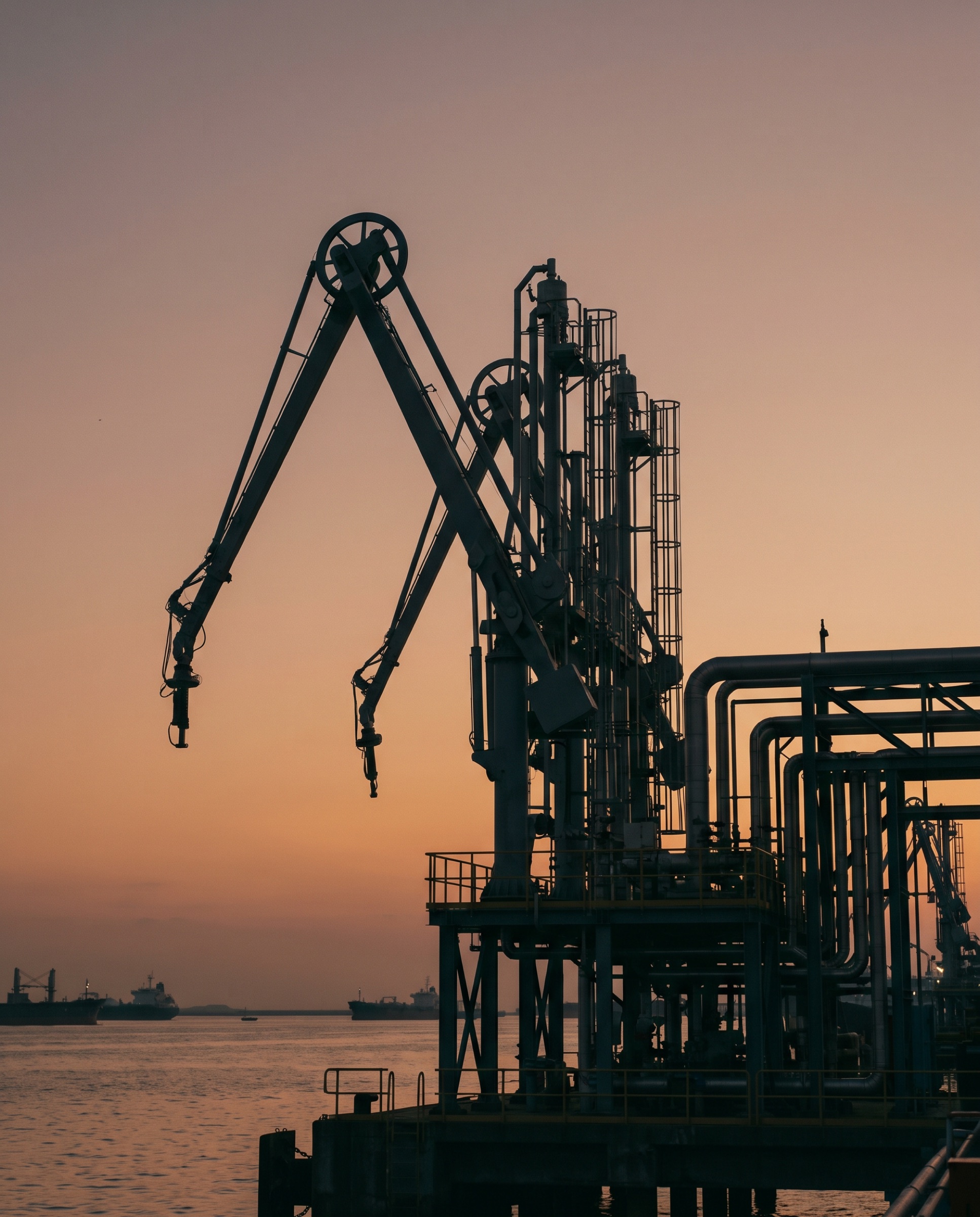 Marine loading arms at an oil terminal at dusk
